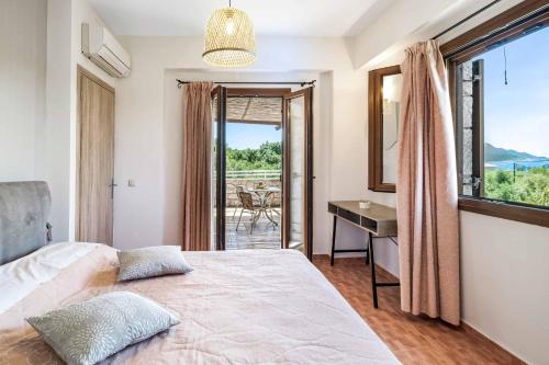 a bedroom with a bed and a desk and a window at Villa Petra in Methoni