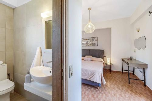 a bathroom with a sink and a bed in a room at Villa Petra in Methoni