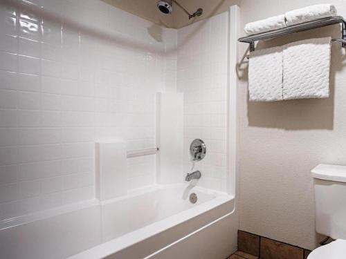 a white bathroom with a tub and a toilet at Best Western Galt Inn in Galt