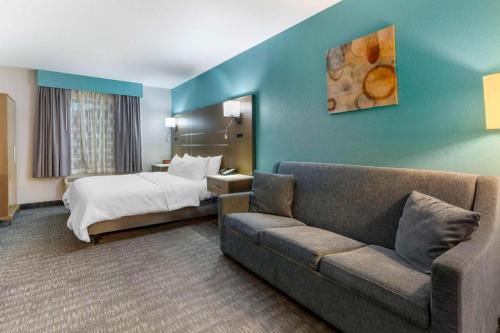 a hotel room with a bed and a couch at Best Western Galt Inn in Galt