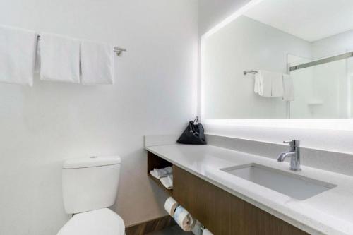 a white bathroom with a sink and a toilet at Best Western Galt Inn in Galt