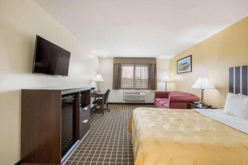 a hotel room with a bed and a living room at Quality Inn in Edgerton