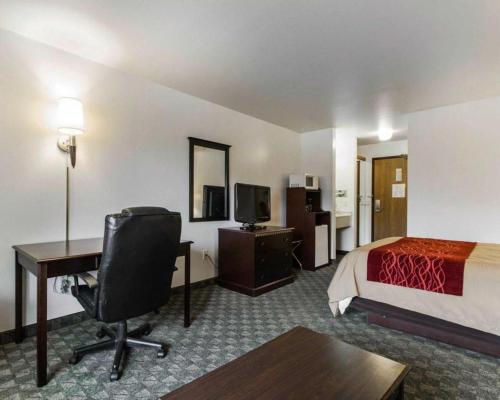 a hotel room with a bed and a desk with a computer at Quality Inn in Edgerton