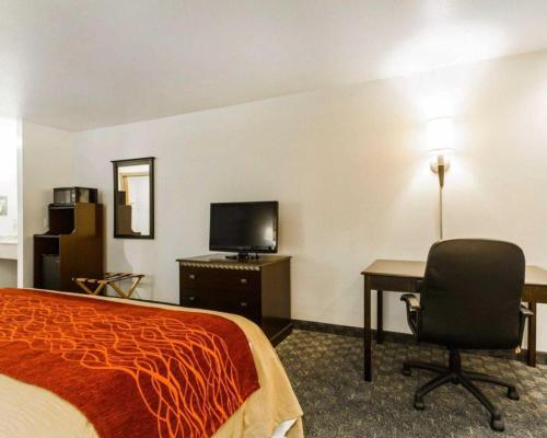 a hotel room with a bed and a desk and a computer at Quality Inn in Edgerton