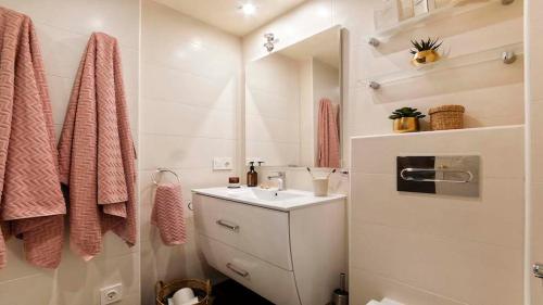 a bathroom with a sink and a mirror at FINALBIR MIMAR- Vistas al mar-Sea view- parking in Albir