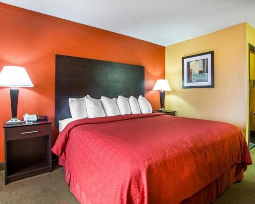 a large red bed in a hotel room at Quality Inn & Suites Kimberly - Appleton East in Kimberly