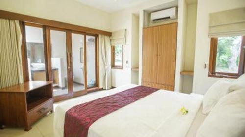 a bedroom with a large white bed and a window at Tanjung Lesung Beach Hotel in Carita