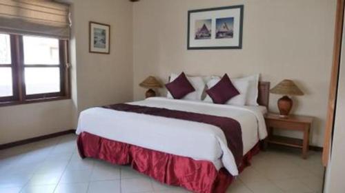 a bedroom with a large bed in a room at Tanjung Lesung Beach Hotel in Carita