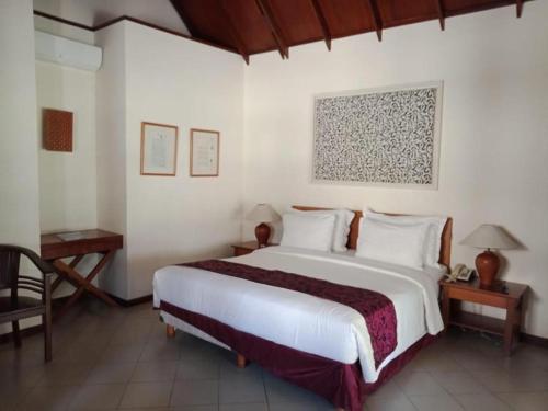 a bedroom with a large white bed in a room at Tanjung Lesung Beach Hotel in Carita