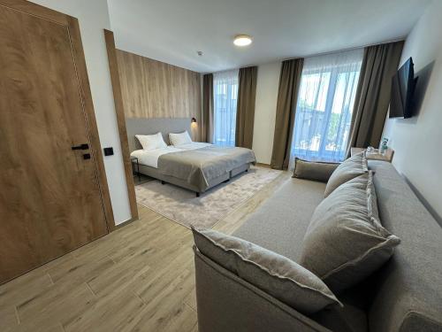 a bedroom with a bed and a couch in a room at Inn West Hotel by Pysanka in Kolomyya