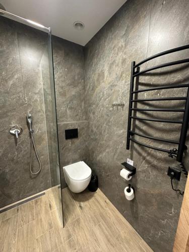 a bathroom with a shower and a toilet at Inn West Hotel by Pysanka in Kolomyya