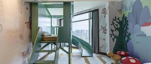 a childrens room with a bunk bed and a window at New Century Grand Hotel Zhuji Yaojiang in Shaoxing