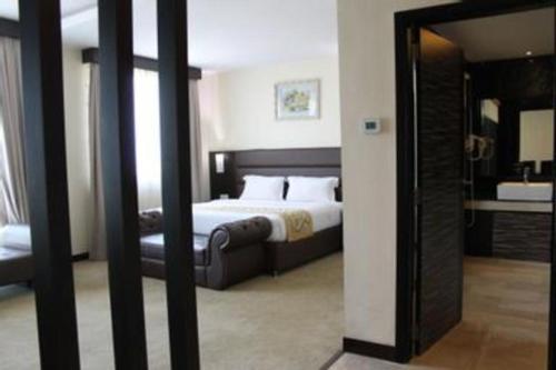 a hotel room with a bed and a mirror at The BCC Hotel & Residence in Nagoya