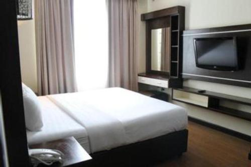 a hotel room with a bed and a flat screen tv at The BCC Hotel & Residence in Nagoya