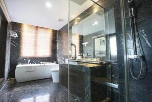 a bathroom with a tub and a sink and a shower at The BCC Hotel & Residence in Nagoya