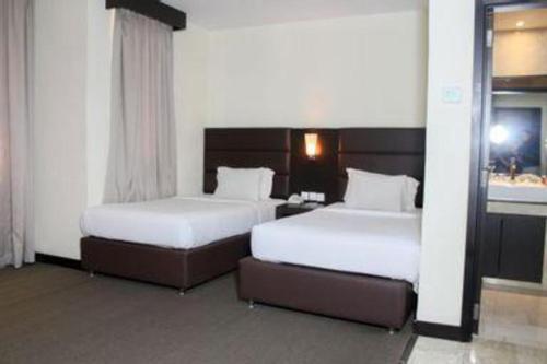 two beds in a hotel room with two at The BCC Hotel & Residence in Nagoya
