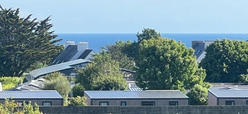 a row of houses with roofs and trees at Penn Ar Bed & Breakfast in Plozévet