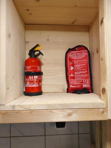 a shelf with a fire extinguisher and a fire hydrant at Private tinyhouse - Blue House in Lõupõllu
