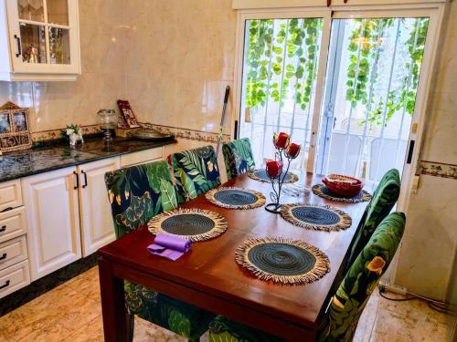 a kitchen with a wooden table with plates on it at Villa lujo Elche in Asprillas