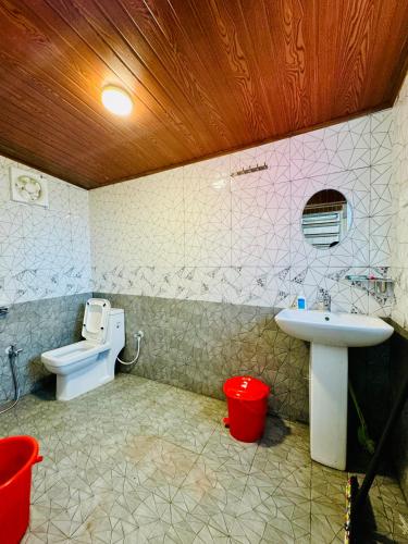 a bathroom with a sink and a toilet at The Tea Tribe Stay in Sonāda