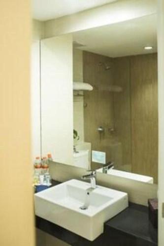 a bathroom with a white sink and a mirror at Bogor Valley Hotel in Bogor