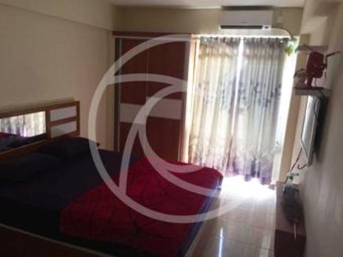 a bedroom with a bed and a room with a window at Bogor Valley Hotel in Bogor