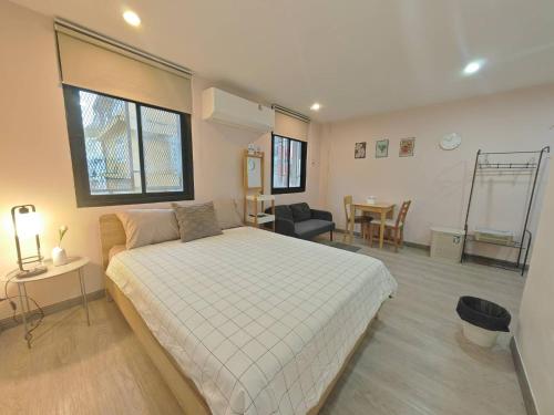 a bedroom with a bed and a living room at 57 Hidden House BKK Chinatown in Bangkok