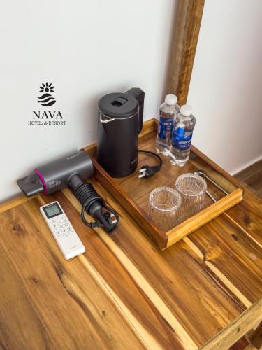 a table with a phone and water bottles on it at Nava Hotel & Resort in Dong Hoi