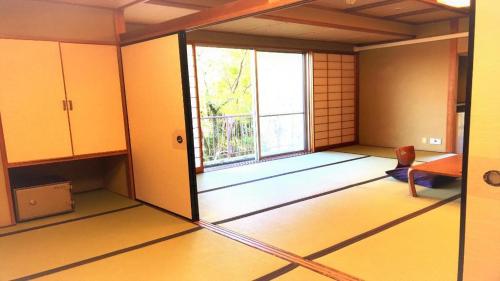 an empty room with a large window in a room at Hotel Miyama in Chichibu