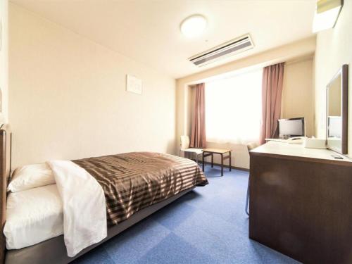 Postel nebo postele na pokoji v ubytování Ichimanri Hotel Golden Century