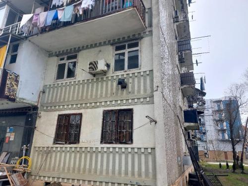 a white building with windows and a balcony at квартира in Poti