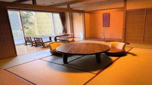 a large room with a table and chairs in it at Hotel Miyama in Chichibu