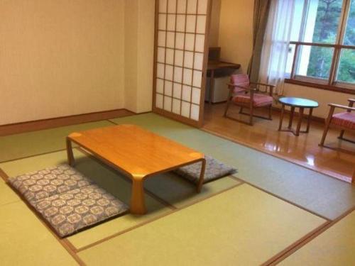 a room with a table and a table and chairs at Kyoto Keburikawa Hotel in Kameoka