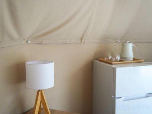 a lamp sitting next to a refrigerator in a room at Kyoto Keburikawa Hotel in Kameoka