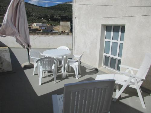 a patio with a table and chairs on a balcony at Favignana Vacanze in Favignana