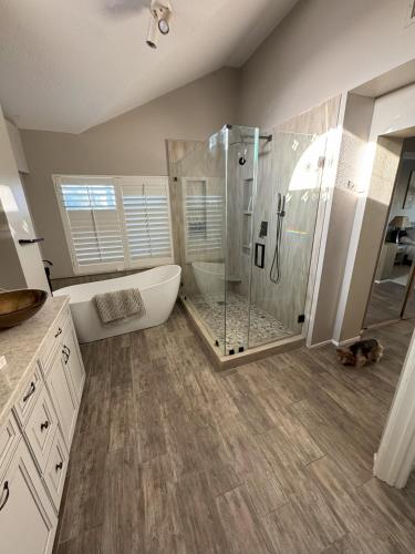 a bathroom with a tub and a shower with a claw foot tub at Riverside Views & Pool Retreat in Riverside