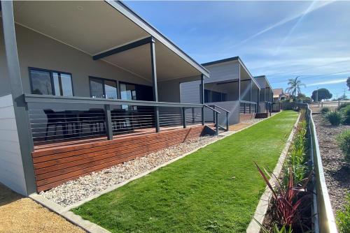a house with a large deck on the side of it at Ardrossan Caravan Park in Ardrossan