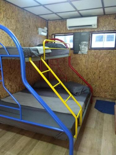 a bunk room with a bunk bed in a bus at MyDesaStay in Sekincan