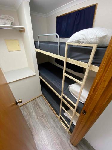 a small room with two bunk beds in it at Ardrossan Caravan Park in Ardrossan
