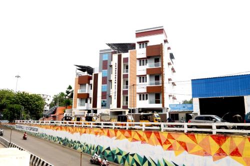 a building with a mural on the side of a street at Sendhuran Residence in Tiruchchirāppalli