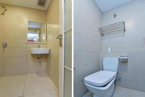 a bathroom with a toilet and a sink at Capital O 90574 Hotel Glo in Kuala Lumpur
