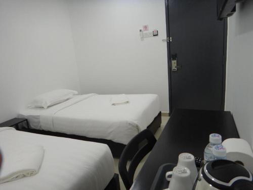 Katil atau katil-katil dalam bilik di Hotel Seri Geliga
