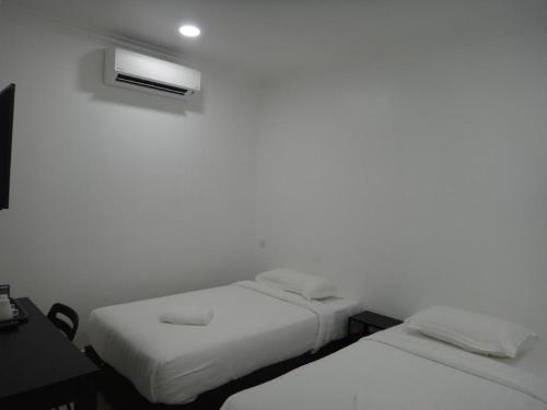 Katil atau katil-katil dalam bilik di Hotel Seri Geliga