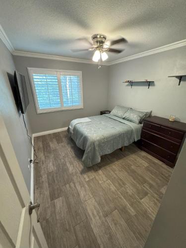 a bedroom with a bed and a ceiling fan at Riverside Views & Pool Retreat in Riverside