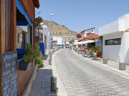 a cobblestone street in a town with buildings at Oroklini Hills in Voroklini