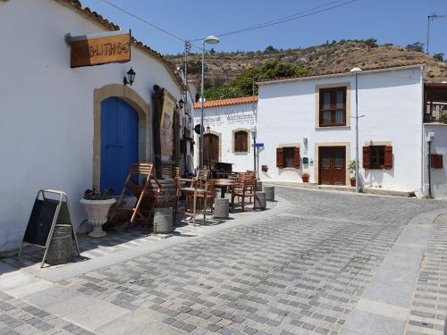 a cobblestone street in a town with white buildings at Oroklini Hills in Voroklini