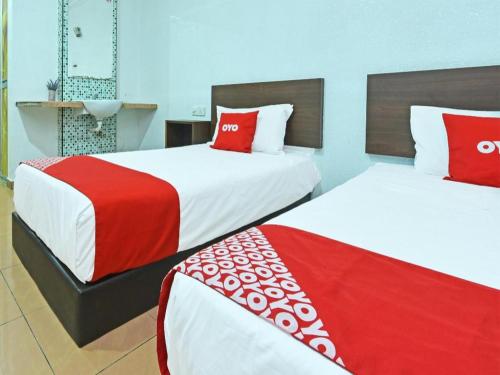 Katil atau katil-katil dalam bilik di OYO 90559 Ummul Motel C Mart
