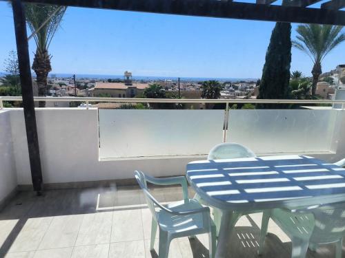 a blue table and two chairs on a balcony at Oroklini Hills in Voroklini