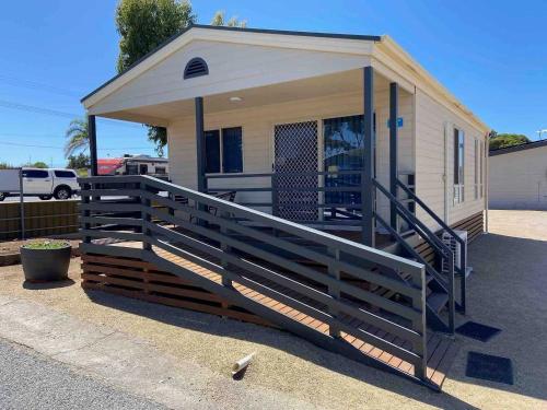 a small house with a porch and a ramp to it at Ardrossan Caravan Park in Ardrossan