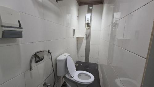 a white bathroom with a toilet and a sink at OYO 90862 Hotel Small City in Klang